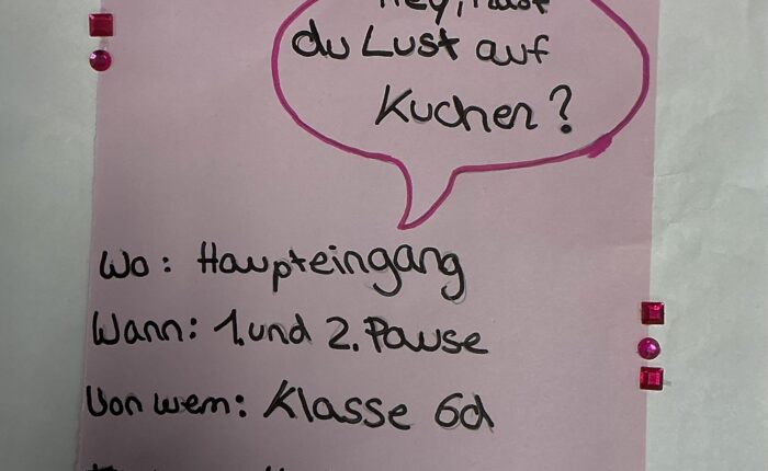 Buntes Plakat zum Kuchenverkauf, mit handgeschriebenen Details und Verzierungselementen.